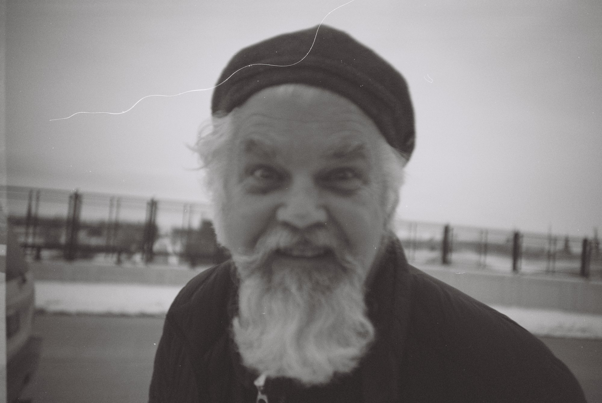 A 35mm portrait with a hair across the hat and dust in the sky